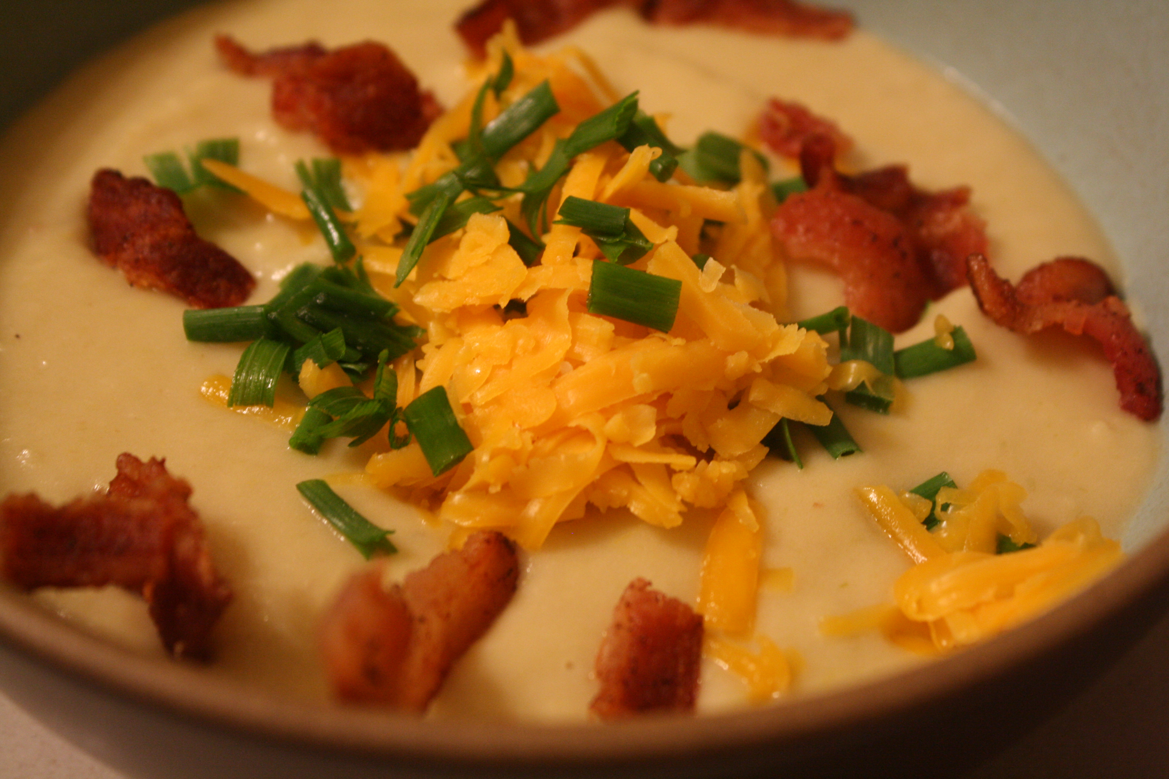 Potato leek soup with bacon and cheese topping